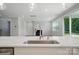 Close up of the kitchen sink and island, with views of the living room, fireplace and backyard at 9846 Quercus Ln, Huntersville, NC 28078