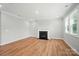A cozy living room with beautiful wood flooring, fireplace, and natural light throughout at 9846 Quercus Ln, Huntersville, NC 28078