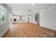 Open-concept living and dining space with wood floors, perfect for entertaining and modern living at 9846 Quercus Ln, Huntersville, NC 28078