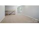 A versatile loft space with neutral carpeting, offering flexible options for relaxing or entertaining at 9846 Quercus Ln, Huntersville, NC 28078