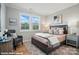 Stylishly furnished main bedroom featuring a large window, elegant decor, plush rug, and comfortable seating at 9846 Quercus Ln, Huntersville, NC 28078