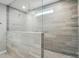 Spacious walk-in shower with sleek gray tiles, modern fixtures, and glass enclosure at 9846 Quercus Ln, Huntersville, NC 28078