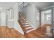Charming staircase with wood treads, iron railing, and bright, open entryway at 9846 Quercus Ln, Huntersville, NC 28078