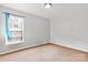A spare bedroom featuring neutral tones and natural light from the window at 1013 Ashwood Pl, Salisbury, NC 28146