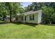 Inviting single-story home with green lawn and a welcoming front porch perfect for relaxing at 1013 Ashwood Pl, Salisbury, NC 28146