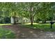 Charming single-story home featuring a driveway and well-maintained front yard with mature trees at 1013 Ashwood Pl, Salisbury, NC 28146