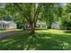 Charming home nestled under a large shady tree in a lush front yard at 1013 Ashwood Pl, Salisbury, NC 28146