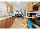 Functional kitchen with wood cabinets, stainless steel dishwasher and access to dining area at 1013 Ashwood Pl, Salisbury, NC 28146
