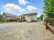The backyard features a wooden deck and a large, gravel parking area with fencing at 1015 Rhode Island Ave, Kannapolis, NC 28083