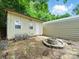 The backyard has a fire pit, an outdoor shed, and mature trees at 1015 Rhode Island Ave, Kannapolis, NC 28083