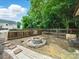 Backyard features a stone fire pit, grass and a metal chair at 1015 Rhode Island Ave, Kannapolis, NC 28083