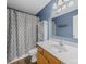 Bathroom featuring a white shower curtain, a mirrored medicine cabinet, and a wood vanity at 1015 Rhode Island Ave, Kannapolis, NC 28083