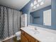 Bathroom with single sink vanity, modern fixtures, and a shower with a patterned curtain at 1015 Rhode Island Ave, Kannapolis, NC 28083