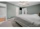 Bedroom with neutral carpet, ceiling fan, access to bath, and an attached closet at 1015 Rhode Island Ave, Kannapolis, NC 28083