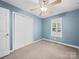 Bedroom with neutral carpet, ceiling fan, window, and a double door closet at 1015 Rhode Island Ave, Kannapolis, NC 28083