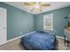 Cozy bedroom with blue walls, a ceiling fan and a comfortable bed at 1015 Rhode Island Ave, Kannapolis, NC 28083
