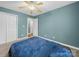 Bedroom featuring a light blue walls, a large closet, and plush carpet at 1015 Rhode Island Ave, Kannapolis, NC 28083