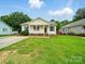 Charming home featuring a cozy front porch with classic railings and well-maintained lawn at 1015 Rhode Island Ave, Kannapolis, NC 28083