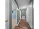 Hallway with wood floors, white trim, and doors leading to other rooms of the house at 1015 Rhode Island Ave, Kannapolis, NC 28083