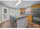 Bright kitchen featuring an island, natural wood cabinets, and modern appliances at 1015 Rhode Island Ave, Kannapolis, NC 28083