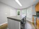 Bright kitchen features a large island, wood floors, and a window overlooking the outdoor scenery at 1015 Rhode Island Ave, Kannapolis, NC 28083