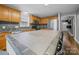 Kitchen featuring a tiled island, wooden cabinets, sleek appliances, and ample counter space at 1015 Rhode Island Ave, Kannapolis, NC 28083