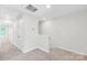 Upstairs hallway featuring carpet and access to attic at 1022 Maltby St, Charlotte, NC 28217