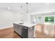 Kitchen island with stainless steel appliances and view of backyard at 1022 Maltby St, Charlotte, NC 28217