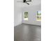 Bedroom showcasing new gray floors, fresh paint and well-lit by two large windows at 103 Wadesborough Pl, Wadesboro, NC 28170