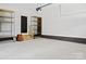 Spacious garage with ample storage shelving and a convenient entrance door at 103 Wadesborough Pl, Wadesboro, NC 28170