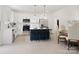 Open-concept kitchen featuring white cabinets, a breakfast bar, and stainless steel appliances at 103 Wadesborough Pl, Wadesboro, NC 28170