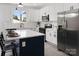 Modern kitchen featuring a central island, white cabinets, stainless steel appliances, and a window at 103 Wadesborough Pl, Wadesboro, NC 28170