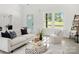 Bright living room with a modern interior design and comfortable white furniture with pops of color at 103 Wadesborough Pl, Wadesboro, NC 28170