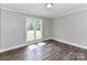 This bedroom features a large window and attractive dark wood flooring at 1117 Hidden Brook Ln, Clover, SC 29710