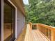 A spacious deck with natural wood flooring overlooks a private backyard with mature trees at 1117 Hidden Brook Ln, Clover, SC 29710