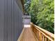 View of the long wooden deck with railing connecting the house to the storage building at 1117 Hidden Brook Ln, Clover, SC 29710