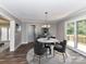 An airy dining room complemented by a marble table set, wood floors, and deck access at 1117 Hidden Brook Ln, Clover, SC 29710