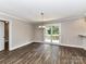 An open dining space with wood flooring, a modern light fixture, and sliding doors to the outside deck at 1117 Hidden Brook Ln, Clover, SC 29710