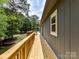 Long wooden deck along the side of the house provides a lovely outdoor space to enjoy nature at 1117 Hidden Brook Ln, Clover, SC 29710