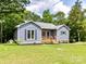 Charming single-Gathering home featuring a welcoming porch and a well-maintained lawn with lush green landscaping at 1117 Hidden Brook Ln, Clover, SC 29710