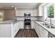 Updated kitchen features stainless steel appliances, white cabinets, and granite countertops at 1117 Hidden Brook Ln, Clover, SC 29710