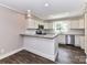 Well-lit kitchen featuring white cabinets, granite countertops, and modern appliances for a delightful cooking experience at 1117 Hidden Brook Ln, Clover, SC 29710