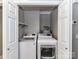 This laundry closet includes a washer, dryer, and some storage space at 1117 Hidden Brook Ln, Clover, SC 29710