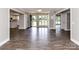 Open-concept living room with hardwood floors, seamlessly connecting to the kitchen and other living spaces at 1117 Hidden Brook Ln, Clover, SC 29710