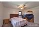 Well-lit bedroom with carpet, a ceiling fan, and natural light from the window at 1145 Craigbrow Cir, Chester, SC 29706