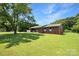 Single story brick home surrounded by lush green lawn and mature trees at 1145 Craigbrow Cir, Chester, SC 29706