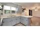 Bright kitchen with light blue cabinets, laminate countertops, breakfast bar, and stainless steel appliances at 1145 Craigbrow Cir, Chester, SC 29706