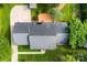 Aerial view of the house, highlighting the roof, deck, driveway, landscaping and the surrounding greenery at 118 Creek Hollow Trl, Belmont, NC 28012