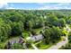 Expansive aerial shot showcases the home surrounded by lush greenery, complemented by a well-maintained lawn at 118 Creek Hollow Trl, Belmont, NC 28012
