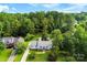 Aerial view of the charming home nestled among lush greenery, showcasing its well-manicured lawn and serene setting at 118 Creek Hollow Trl, Belmont, NC 28012